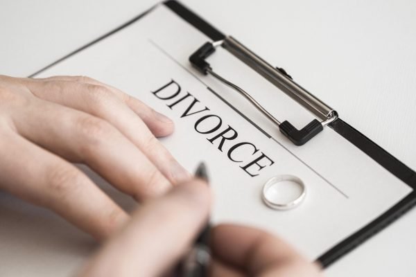 close-up-male-signing-divorce-contract